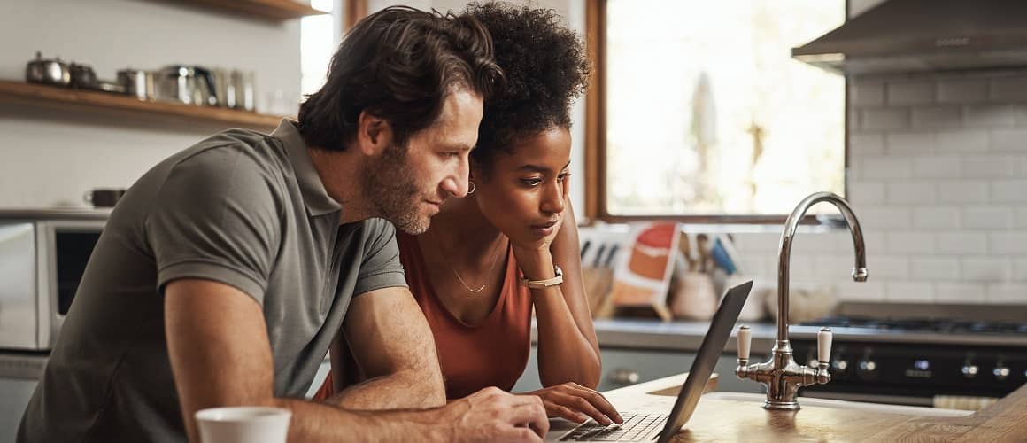 Couple doing financial planning on a laptop, indicating financial management or budgeting.