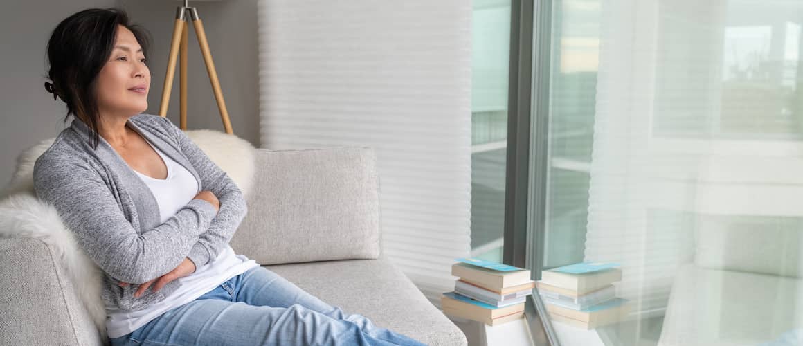 A woman relaxing at home, suggesting a comfortable and serene atmosphere in a residential setting.