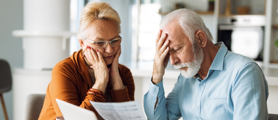 Frustrated mature couple having problems with paying their bills