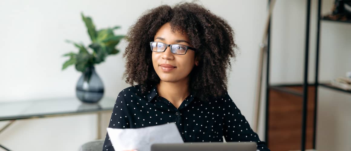 RHB Assets From IGX: Young woman working on a laptop in a modern office