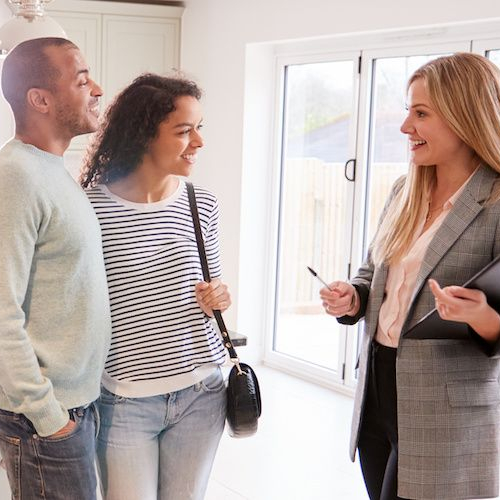 Couple looking at a home, potentially discussing or exploring a property they're interested in purchasing.