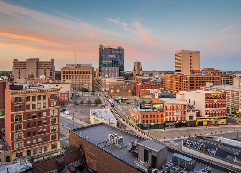 RHB Assets From IGX: A vibrant street view of downtown Detroit, Michigan with historic buildings and a bustling atmosphere.