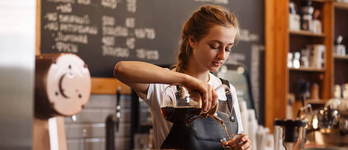 Young woman working as a barista in a hip independent cafe.