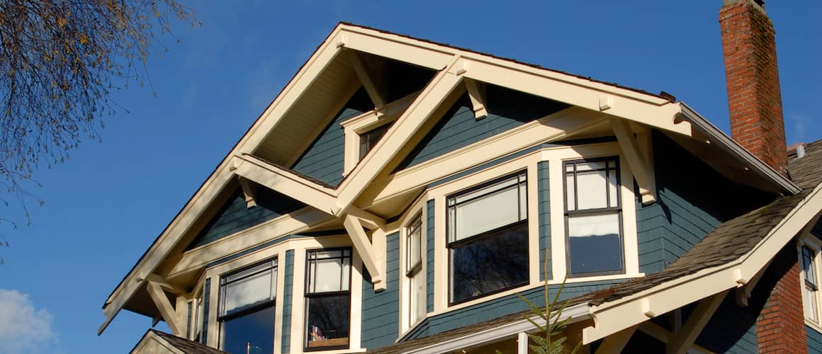 Brown beach house with porch leading to beachfront