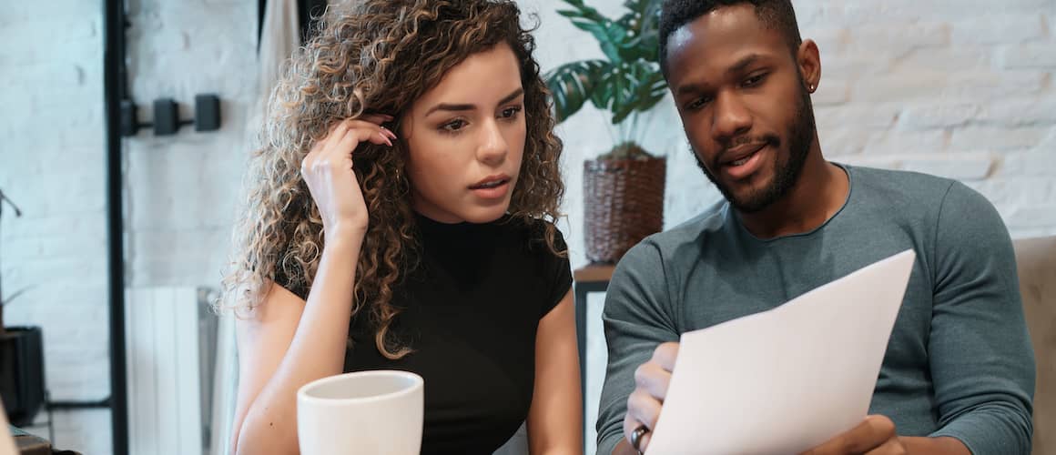 Young couple looking at their finances together.