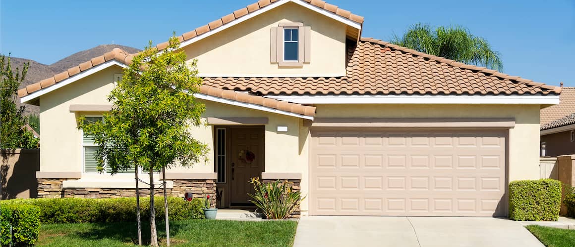 A beige single-family home, potentially showcasing a residential property in a serene neighborhood.