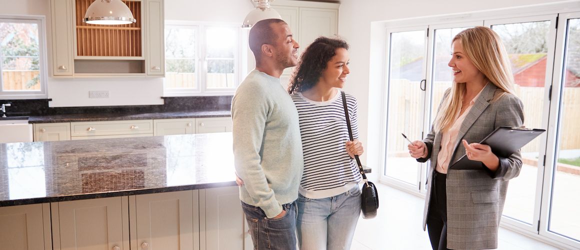 Couple looking at a home, potentially discussing or exploring a property they're interested in purchasing.