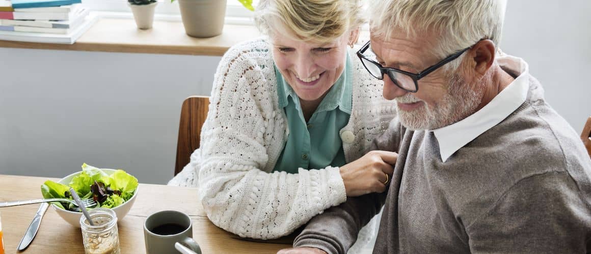 An older couple enjoying lunch together, potentially depicting retirement or leisure time at home.