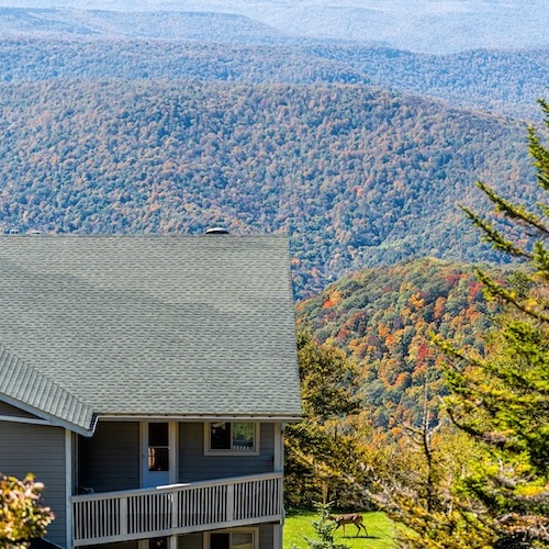 Large house with porch on hill overlooking the Appalachian mountains in Showshoe, West Virginia.