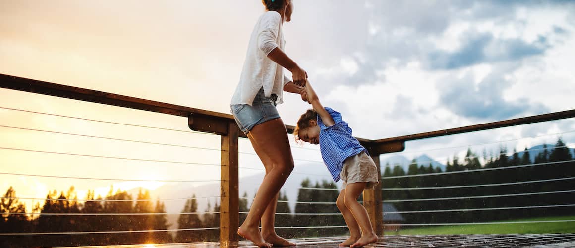 A woman enjoying with her child on the balcony.