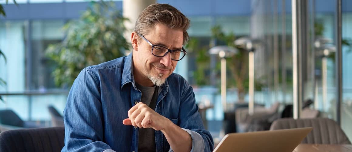 Middle aged man on computer.