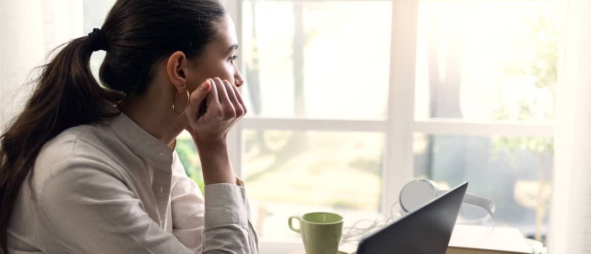 An image showing a woman engrossed in her thoughts possibly related to some real estate investment or work.