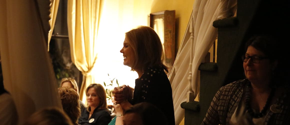 A woman smiling on a party at her new home