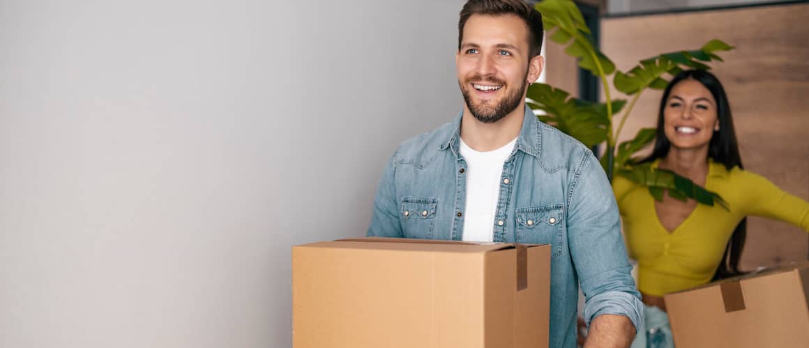 A young couple moving in, signifying the excitement of settling into a new home.