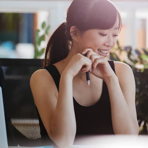 A woman looking at a deed, potentially involved in property ownership or real estate matters.