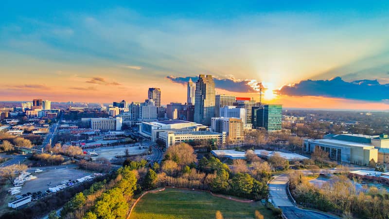 RHB Assets From IGX: Downtown Raleigh, North Carolina, with a mix of modern buildings, green spaces, and a blue sky backdrop.