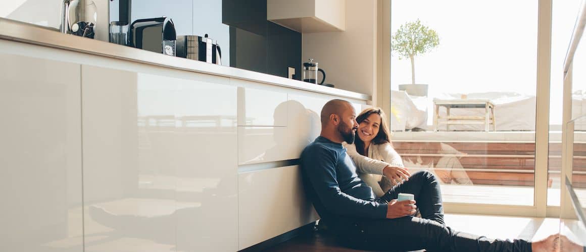 Image of couple enjoying breakfast on floor of new, remodeled kitchen