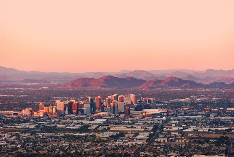 RHB Assets From IGX: Phoenix cityscape with buildings and mountains in the background.