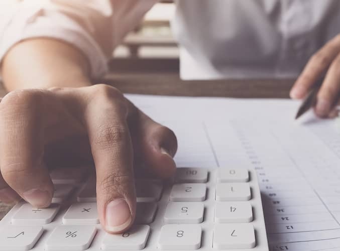 Close up of man calculating figures.