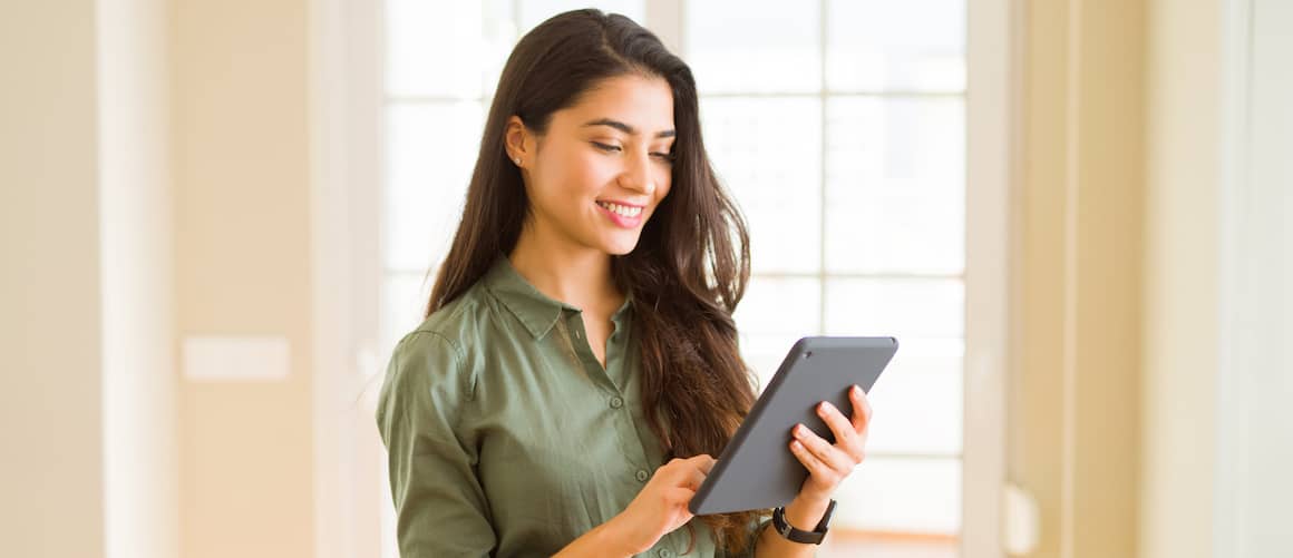 woman in army green with tablet