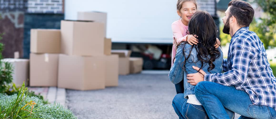 Image of family standing in front of new home.