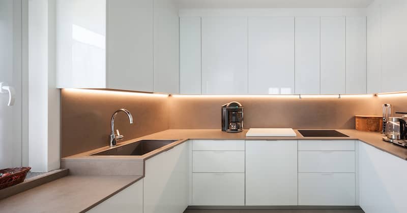 RHB Assets From IGX: A bright and modern rental kitchen with under-cabinet lighting.