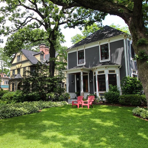 Two large homes with lawn chairs in Chicago.