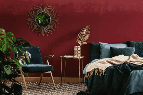 A modern bedroom with deep red walls.