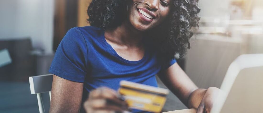 Woman using credit card online.