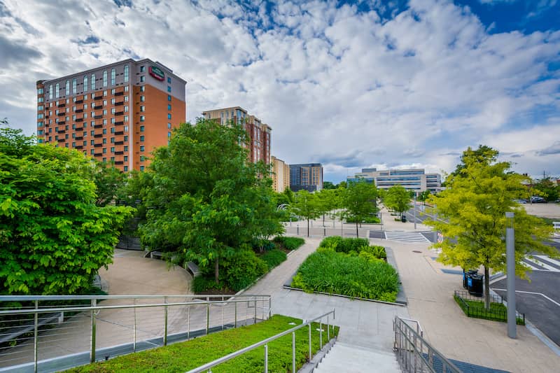 RHB Assets From IGX: Vibrant Navy Yard district in Washington D.C., showcasing modern buildings, waterfront, and lush green spaces.