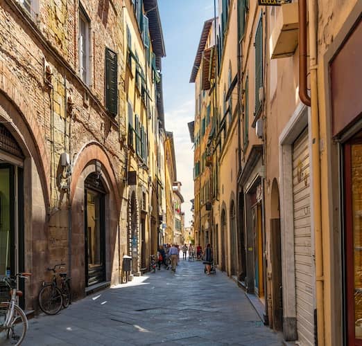 Narrow alley with shops above businesses