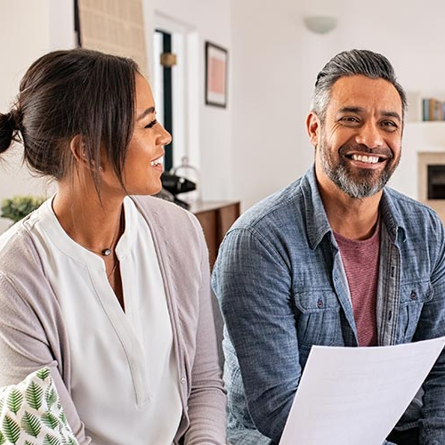 A couple talking with a mortgage lender, potentially in a home buying process.