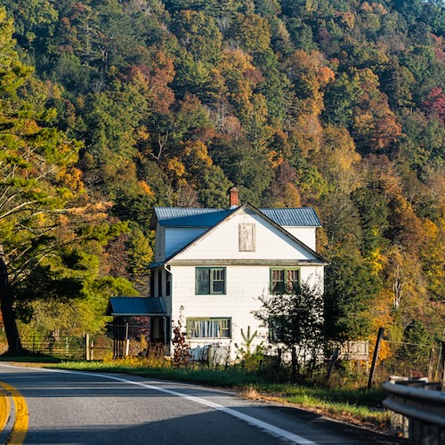 Home on roadside against backdrop of the Appalachian mountains.
