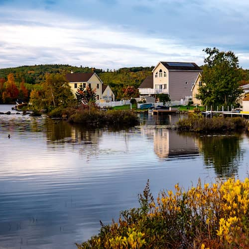 Lake houses or waterfront properties along a serene lake.
