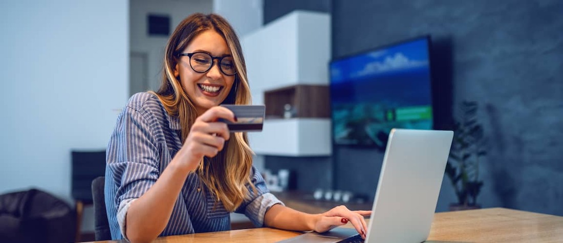 Woman using debit card online.