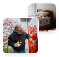 Older adult painting a red front door outside a home