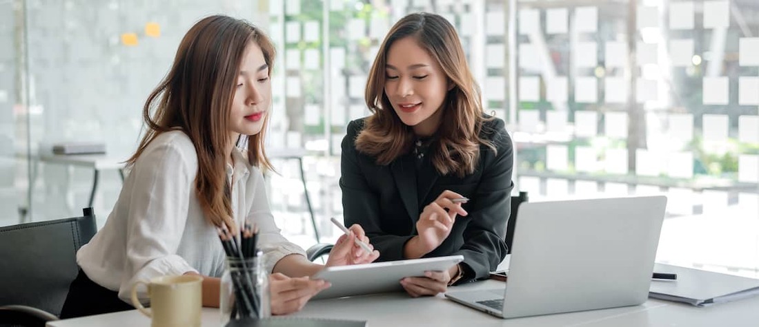 Two women using tablet together.