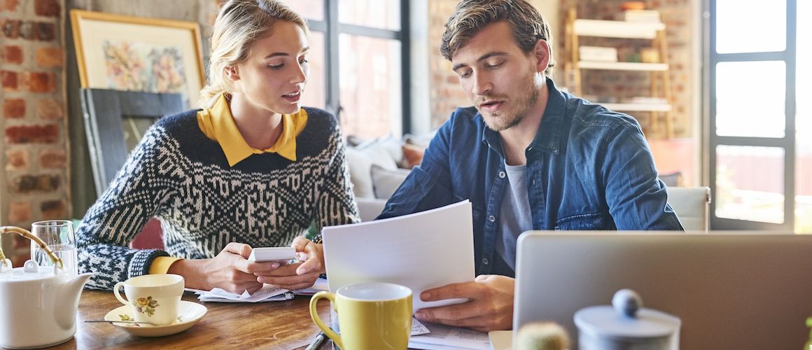 Husband and wife working on taxes together, indicating financial management or tax preparation.