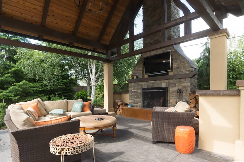 RHB Assets From IGX: Outdoor patio with a mounted TV and comfortable seating