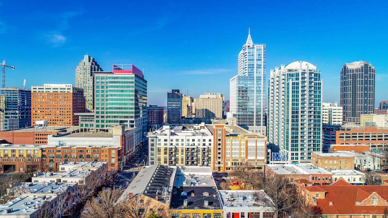 RHB Assets From IGX: Raleigh, North Carolina skyline with lush green trees.